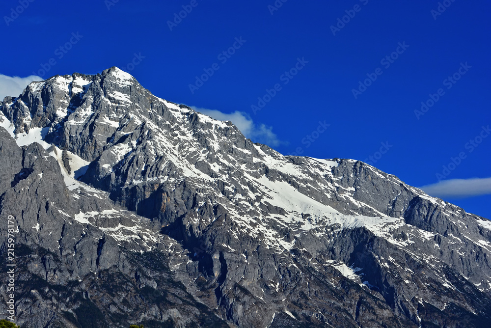 summit of high mountain covered by snow in Lijiang, China summit of high mountain covered by snow in Lijiang, China