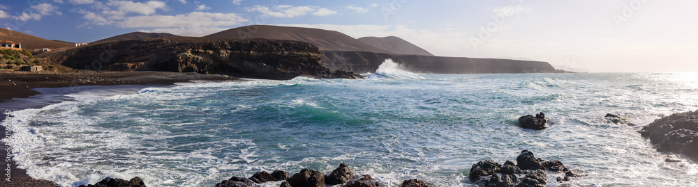Panorama view of black sand beach in Lanzarote on sunset