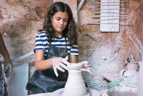 Ceramic dishes in working process. Creating ceramic pieces. Tradicional ceramic factory in spain. Father teaching the art of ceramic making.