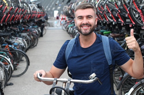 Man giving thumbs up in bicycle parking lot