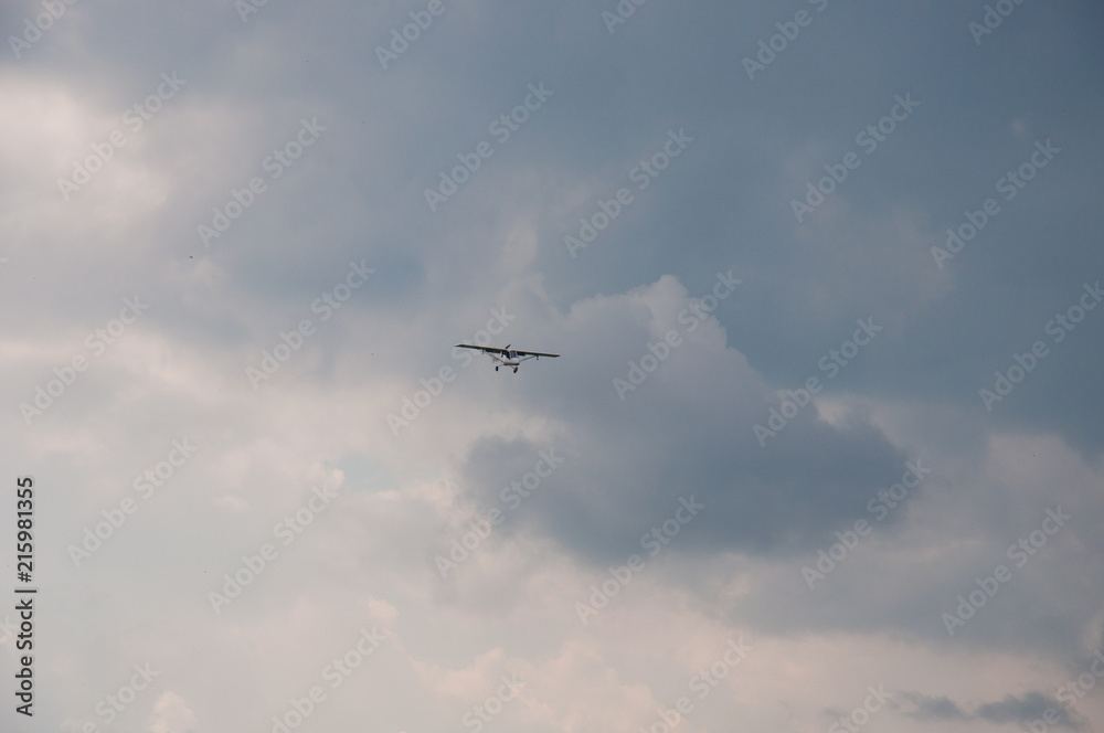 White plane in the blue sky. The concept of travel, recreation and technology. The aircraft is landing