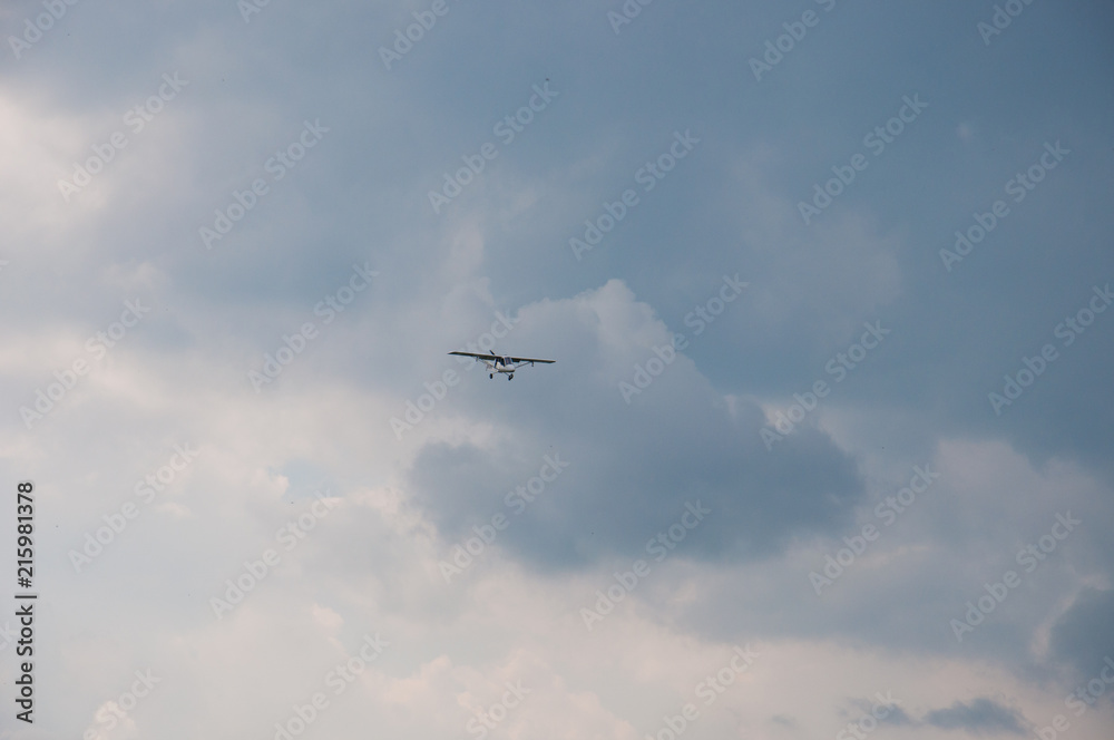 White plane in the blue sky. The concept of travel, recreation and technology. The aircraft is landing White plane in the blue sky. The concept of travel, recreation and technology. The aircraft is landing