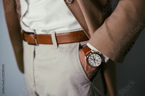 Vintage smart casual outfit outdoor.Fashion model man posing in office.Suited man posing.closeup fashion image of luxury watch on wrist of man.body detail of a business man.Not isolated.