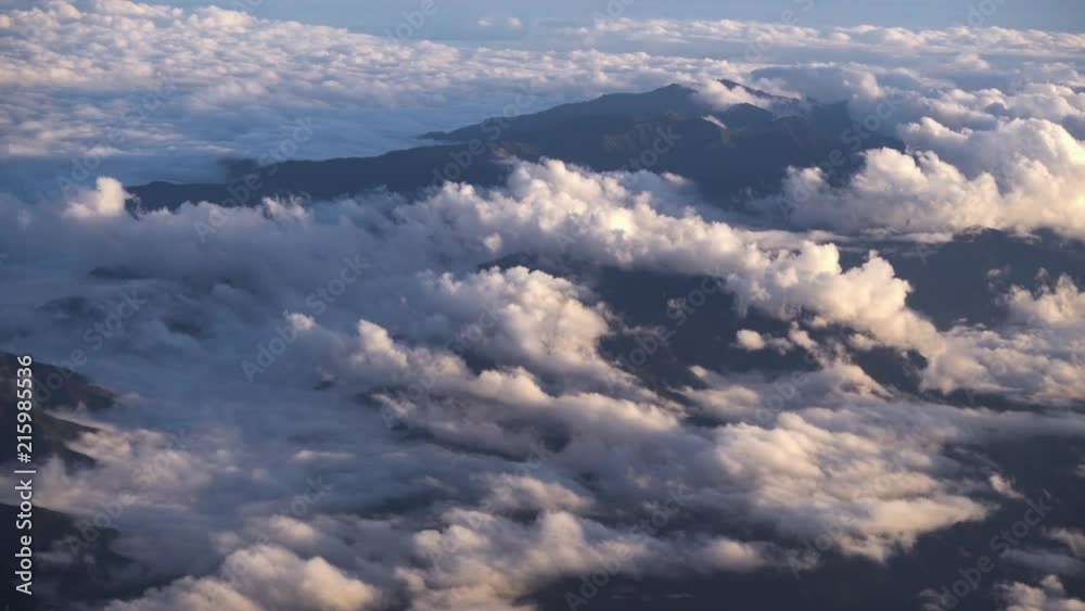 Aerial view of flowing clouds over Japan Alps mountain. Airplane shot. Aerial view of flowing clouds over Japan Alps mountain. Airplane shot.