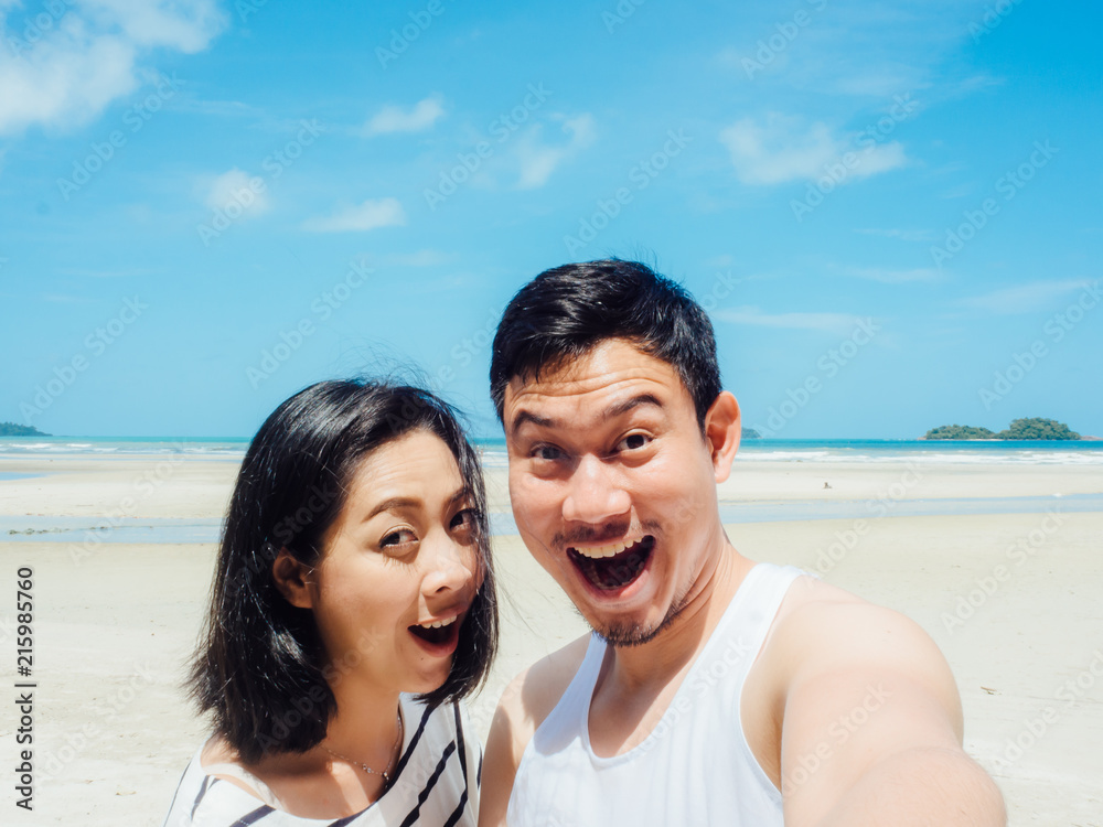 Couple tourist selfie on sunny summer beach.