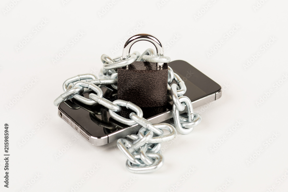 Smart phone in a chain with lock. Security, data protection and software. Smart phone in a chain with lock. Security, data protection and software.