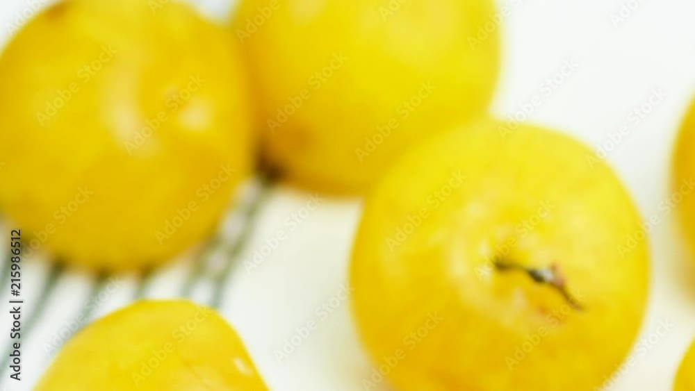 Tilting movement of camera on bunch of ripe juicy organic yellow plums on white cotton towel on garden table. Autumn fall produce harvest. Provence rural kitchen interior. Cozy atmosphere Tilting movement of camera on bunch of ripe juicy organic yellow plums on white cotton towel on garden table. Autumn fall produce harvest. Provence rural kitchen interior. Cozy atmosphere