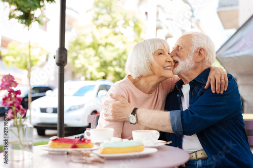 Obraz na plátně Light flirt. Cheerful senior couple flirting and sitting at cafe
