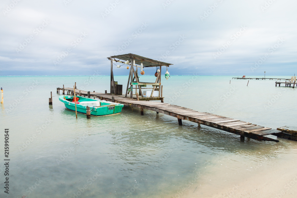 Small Boat, Mooring Posts, Buoys and Overcast Tropical Sea.