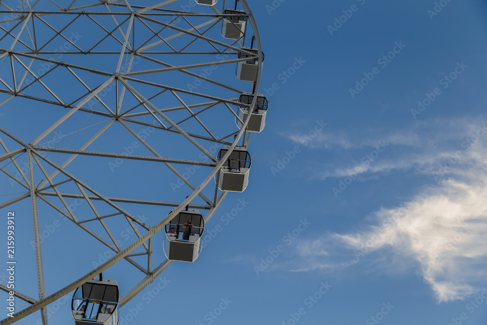 Fototapeta premium Very large Ferris wheel against the blue sky.