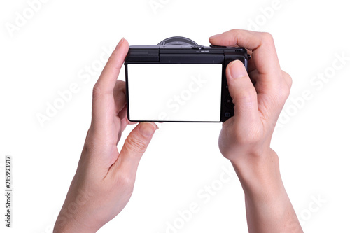 Mirrorless photo camera  in hand isolated on white background