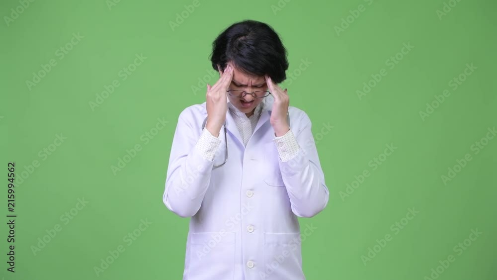Stressed woman doctor with short hair having headache Stressed woman doctor with short hair having headache