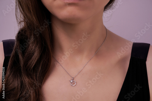 Girl wearing a gold necklace with pendant
