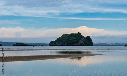 seascape with island and sand beach in morning sky