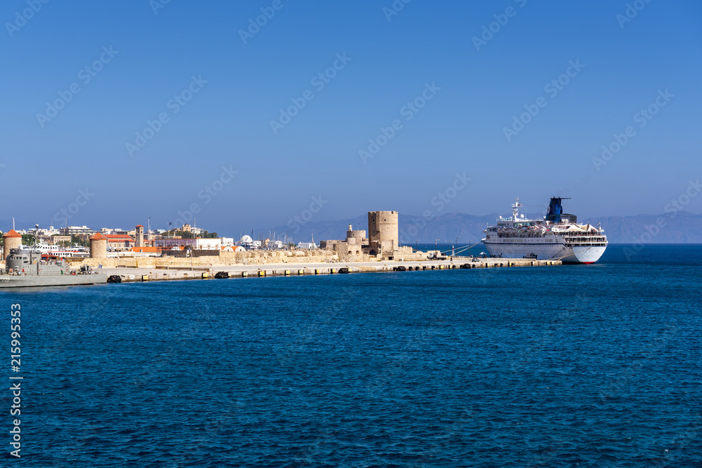 View of Mandraki port with clear blue water in Rhodes city. Famous tourist destination in South Europe. Rhodes island, Dodecanese, Greece.
