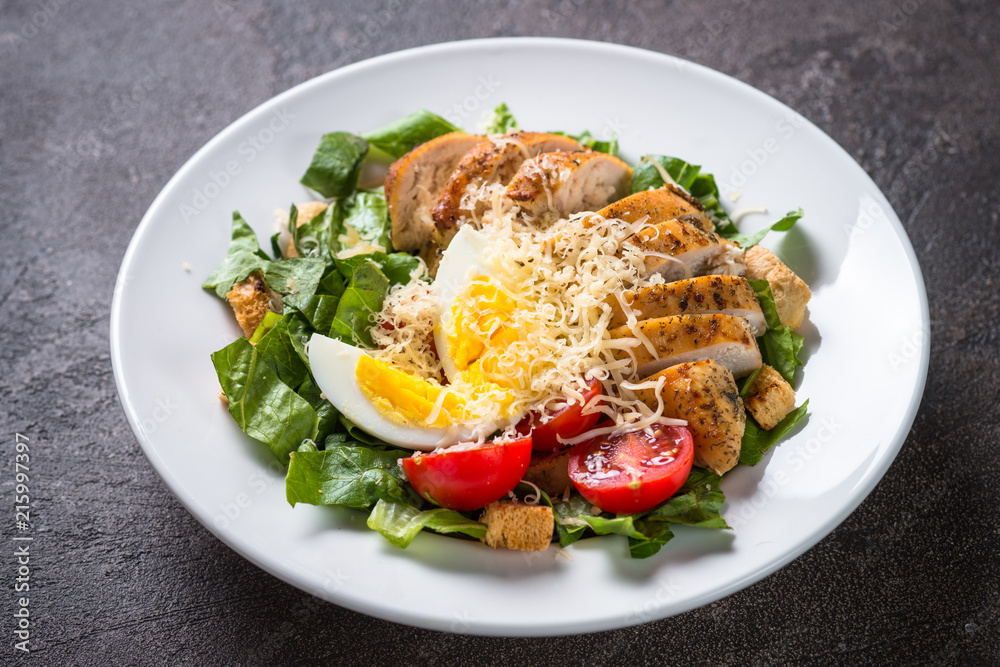 Caesar salad with chicken breast and tomatoes. Caesar salad with chicken breast and tomatoes.