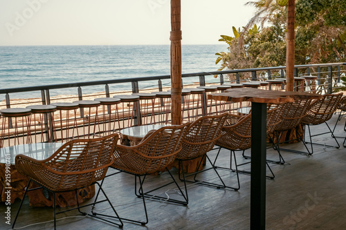 tables and chairs on the terrace by the sea in Marbella city, Spain