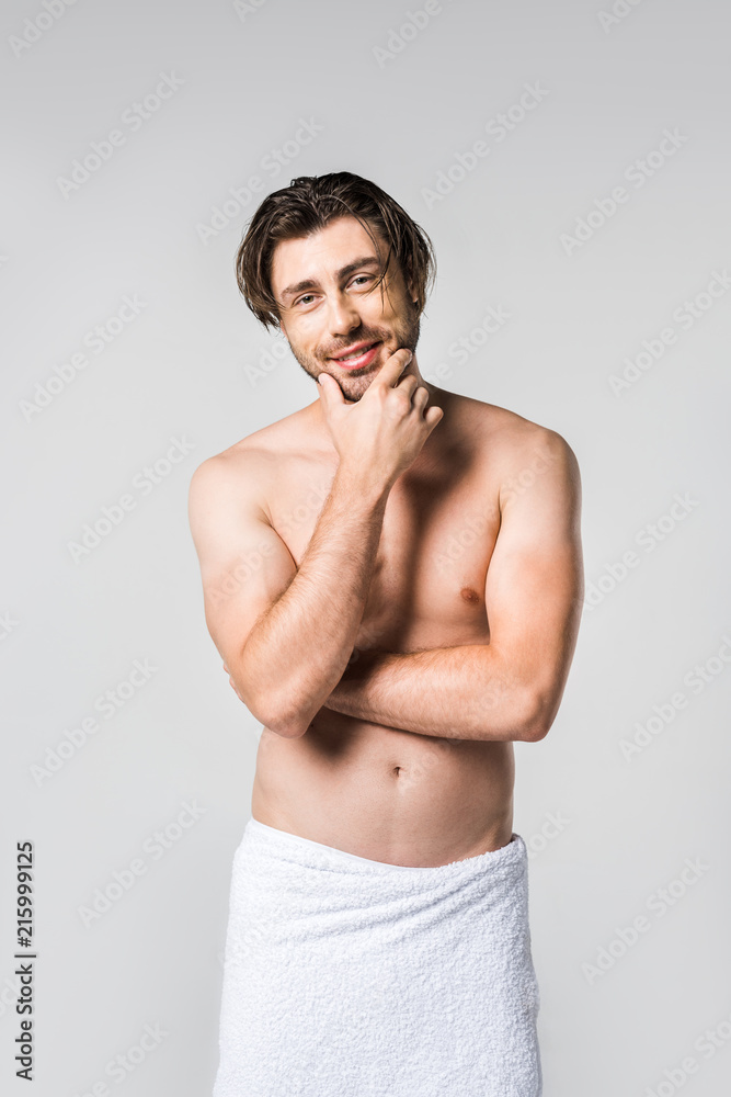 portrait of handsome man in white towel looking at camera isolated on grey portrait of handsome man in white towel looking at camera isolated on grey