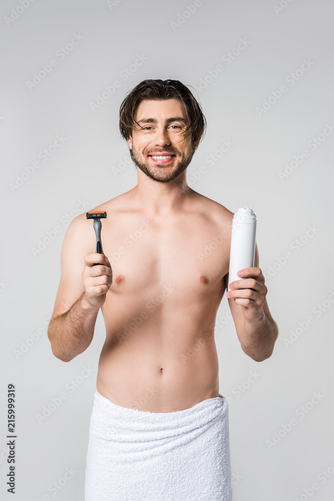 portrait of smiling man in white towel with razor and shaving foam in hands isolated on grey portrait of smiling man in white towel with razor and shaving foam in hands isolated on grey