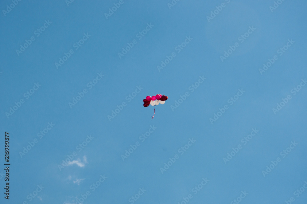 Background colorful balloons flying in the blue sky with clouds Background colorful balloons flying in the blue sky with clouds