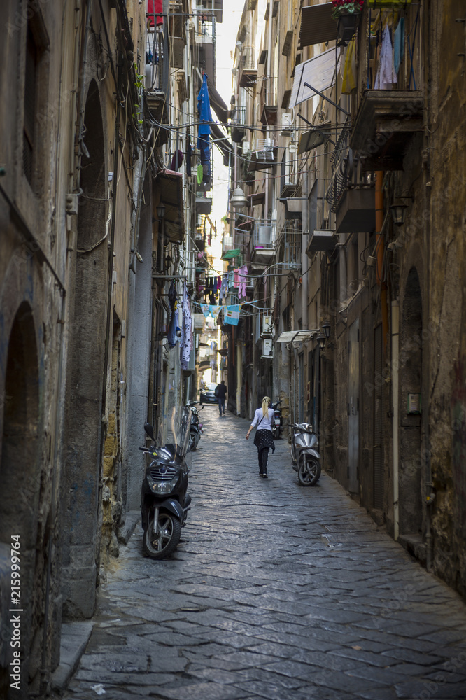 View of dark shady alley of Naples' historic center.