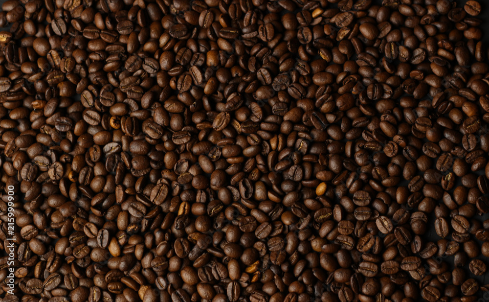 Coffee grains on a dark background. A delicious fragrant coffee of the best varieties. Coffee texture. Coffee beans background Coffee grains on a dark background. A delicious fragrant coffee of the best varieties. Coffee texture. Coffee beans background