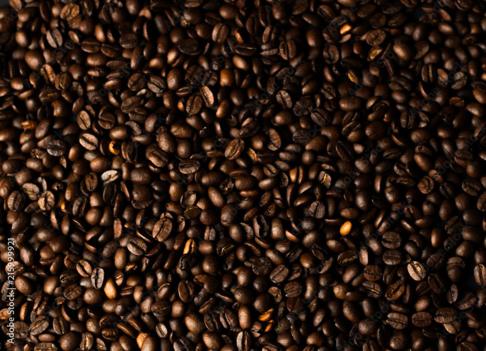 Coffee grains on a dark background. A delicious fragrant coffee of the best varieties. Coffee texture. Coffee beans background Coffee grains on a dark background. A delicious fragrant coffee of the best varieties. Coffee texture. Coffee beans background