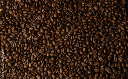 Coffee grains on a dark background. A delicious fragrant coffee of the best varieties. Coffee texture. Coffee beans background
