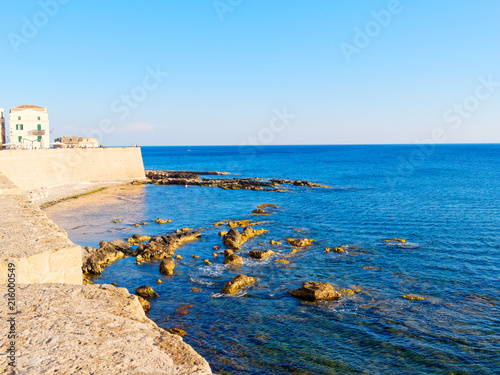 View of the sea and a fragment of Alghero defensive walls. Sardinia, Italy.