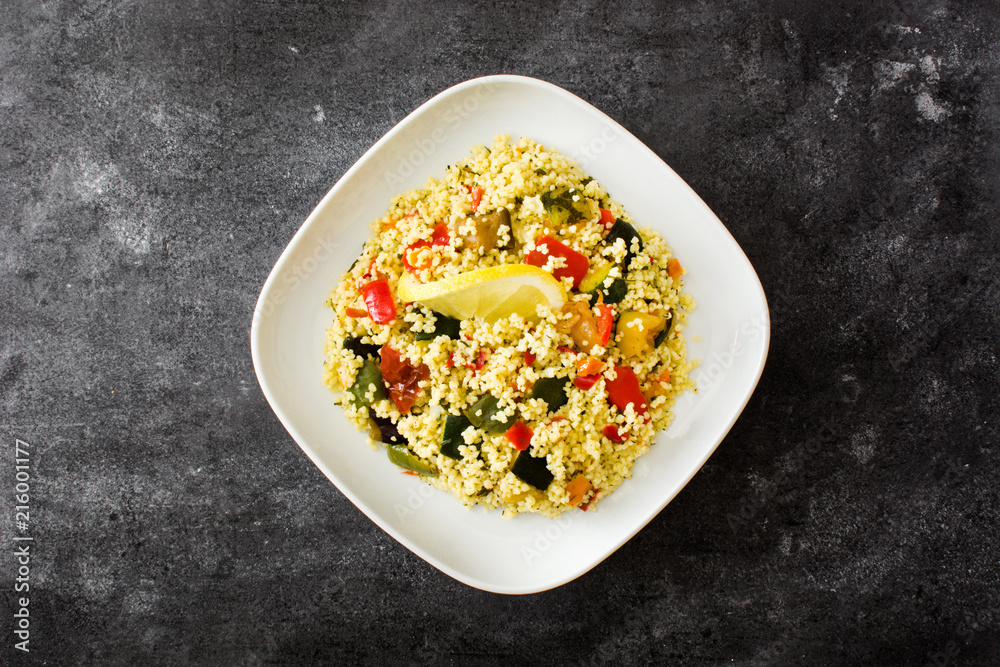 Couscous with vegetables on black stone. Top view. Couscous with vegetables on black stone. Top view.