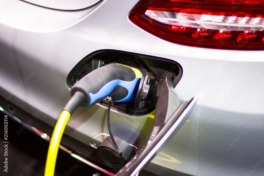 Fototapeta premium the charging the battery for the car new Automotive Innovations the power supply plugged into an electric car being charged.