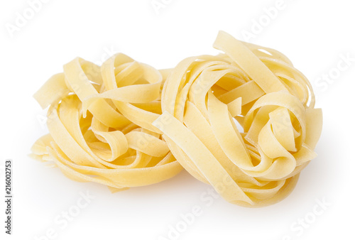 Uncooked nests of tagliatelle pasta isolated on white background with clipping path