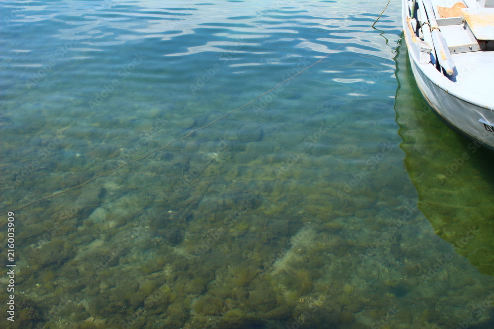 Obraz premium The clear water of the Mediterranean Sea ner Tassos Island and a boat