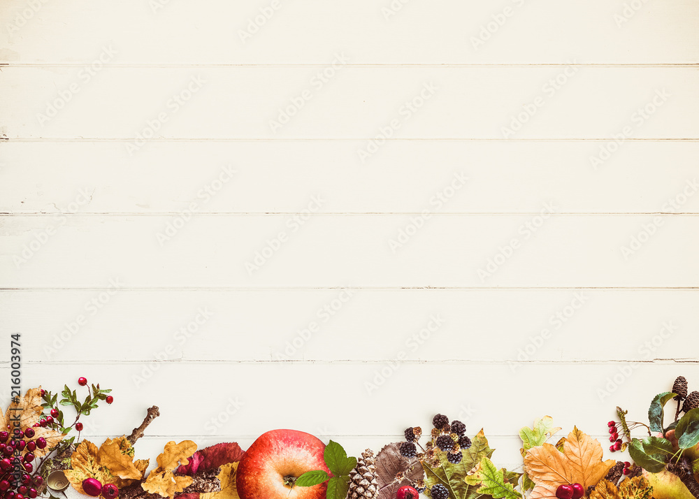 vintage autumn leaves, wood and berries on wooden background