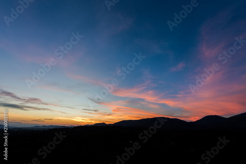 Cloudscape after sunset above the silhouette hills © bouybin