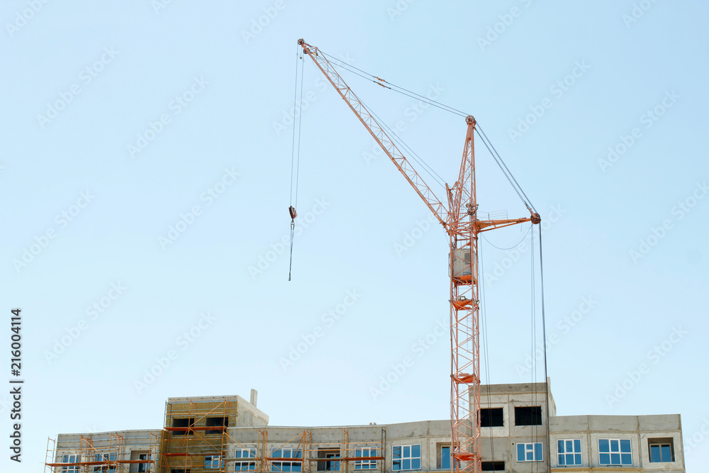 Picture of construction crane building home