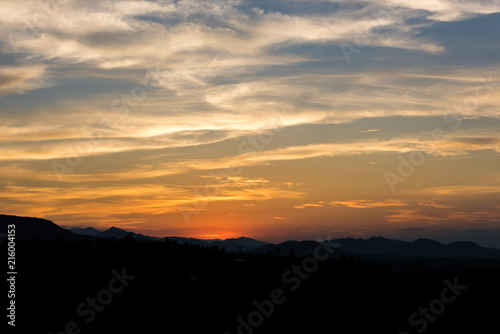 Fototapeta Naklejka Na Ścianę i Meble -  Cloudscape after sunset above the silhouette hills