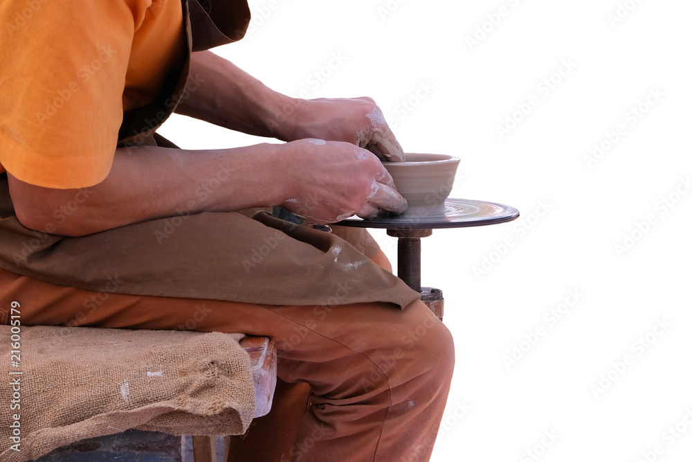 Obraz premium Potter in brown apron makes clay pottery on circle. Craftsmanship concept. Isolated on white background.