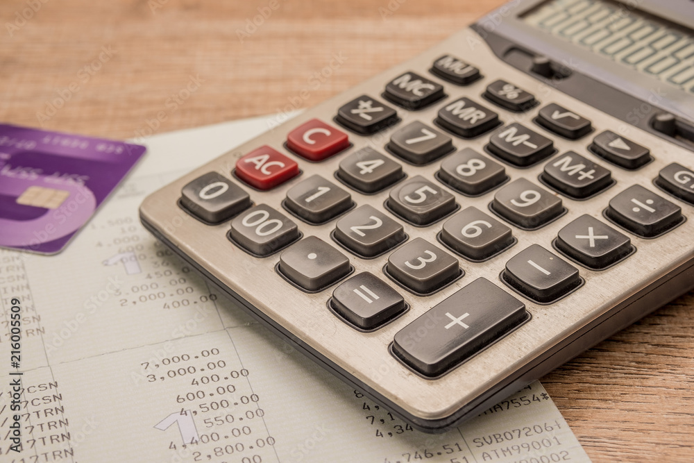 Calculator, cash card, bankbook Put on a wooden table. Calculator, cash card, bankbook Put on a wooden table.