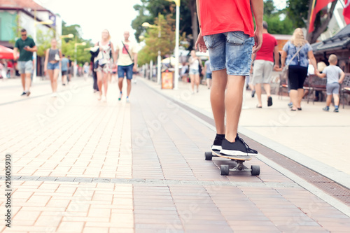 Skateboarder riding skateboard through the streets many people walking © Aleksej