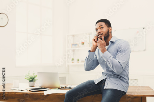 Young black businessman having phone talk