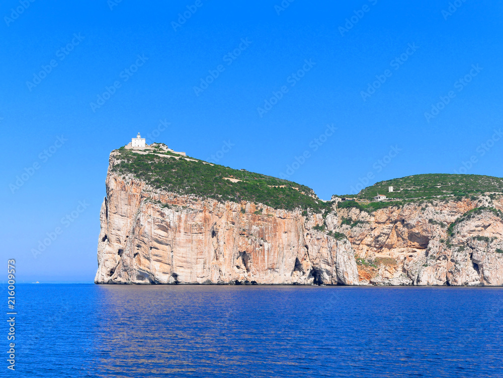 A beautiful view of the cliffs with the lighthouse Capo Caccia (Alghero). Sardinia, Italy