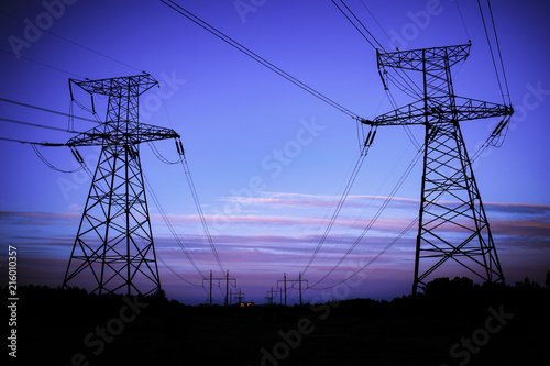 high-voltage power lines at sunset. electricity distribution station .