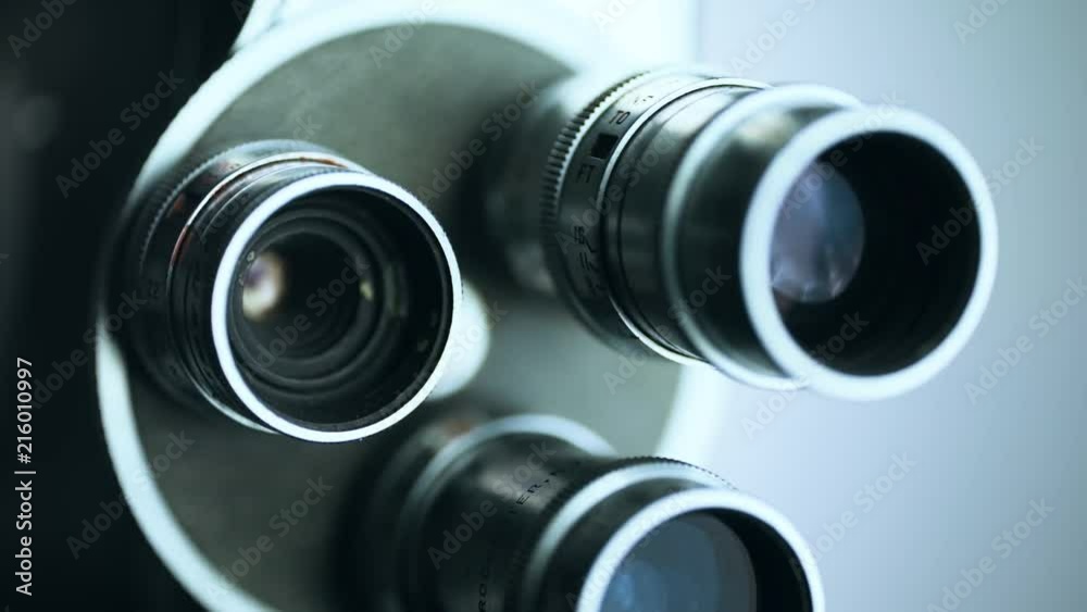 Macro close up of old 8mm film camera lenses with rack focus down to camera body