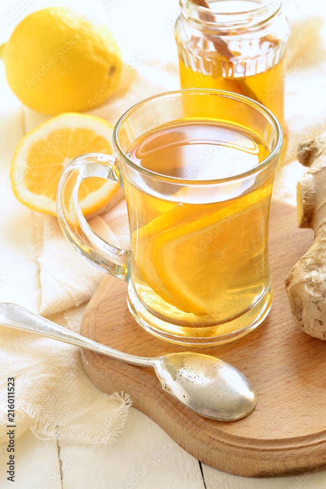 Lemon ginger drink with honey, tea, vertical Lemon ginger drink with honey, tea, vertical