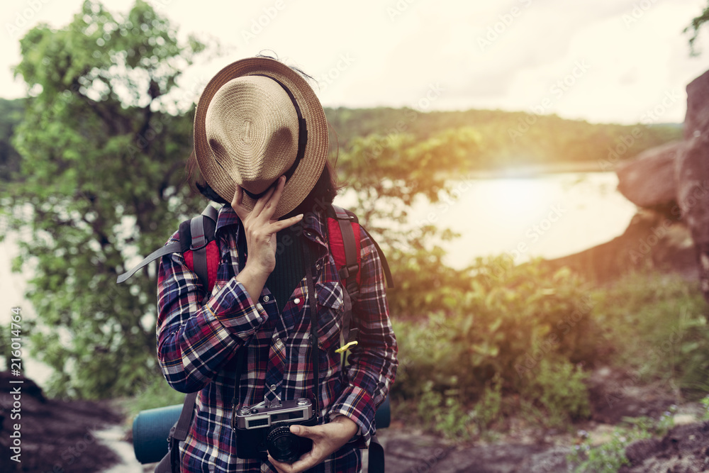 Fototapeta premium Hipster style women backpacker traveller standing hat off