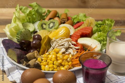 Salads ,eggs and milk placed on wooden table