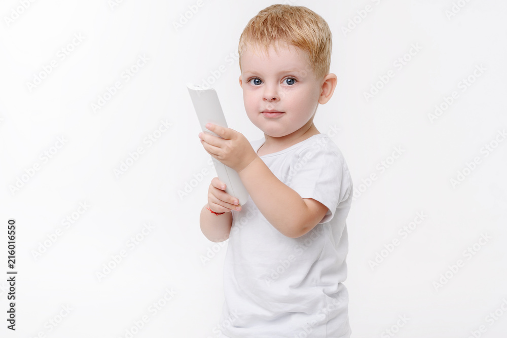 Small kid and TV remote control on white isolated background Small kid and TV remote control on white isolated background