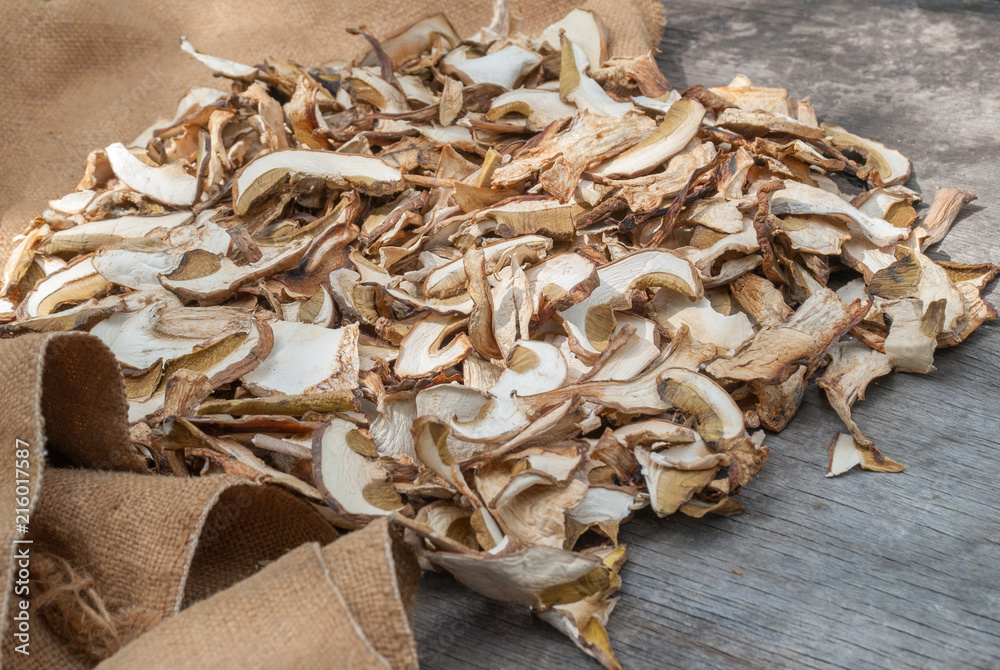 Dried porcini mushrooms on a wooden table. Dried porcini mushrooms on a wooden table.