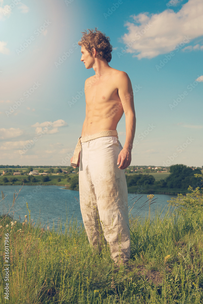 A young man posing with a bare torso. A young man posing with a bare torso.